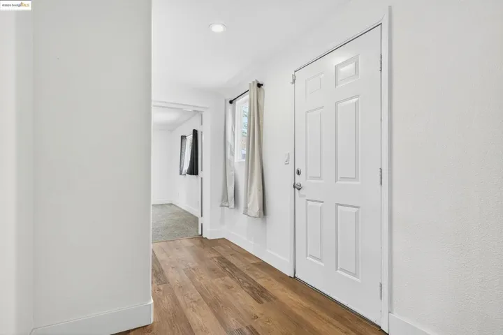 Entryway with wood finished floors and baseboards