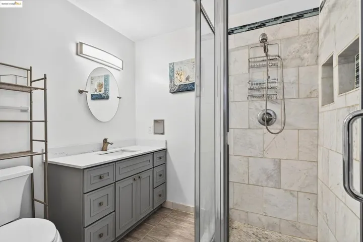 Full bath featuring a shower stall and vanity