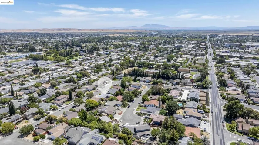 View of property location featuring nearby suburban area and a mountain backdrop