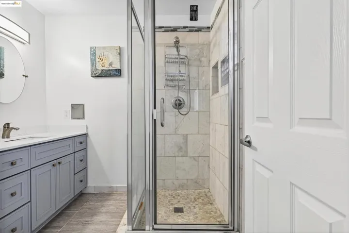 Bathroom featuring a stall shower and vanity