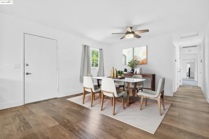 Dining space with wood finished floors and ceiling fan