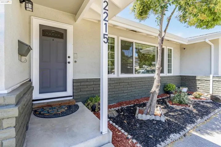 Entrance to property with stucco siding and stone siding