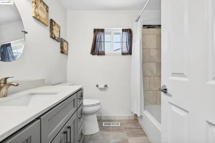Bathroom with vanity and shower / tub combo