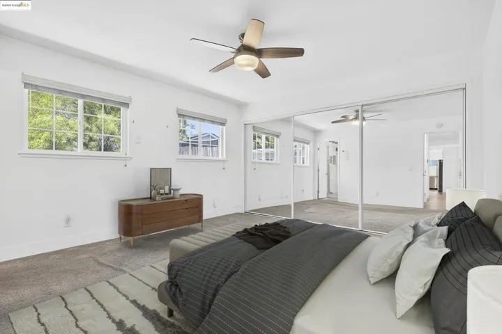 Bedroom with carpet floors, a ceiling fan, and a closet