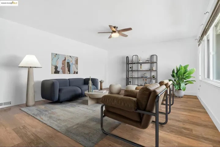 Living room with a ceiling fan and wood finished floors