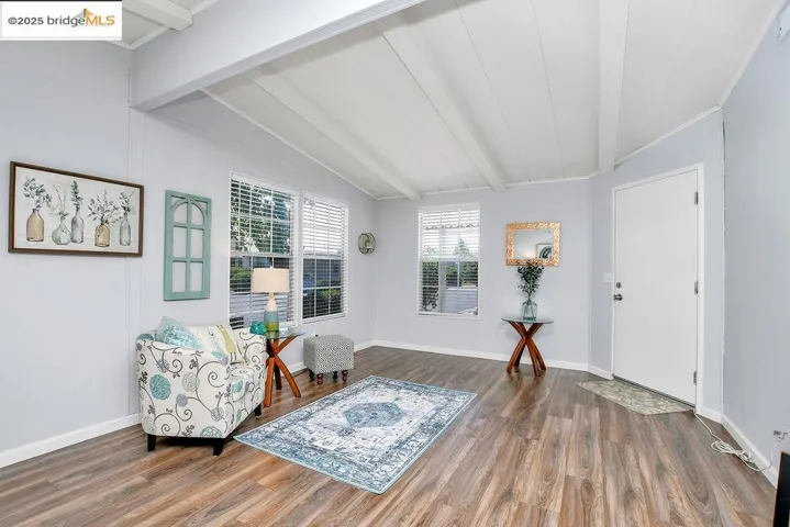 Sitting room with wood finished floors and baseboards