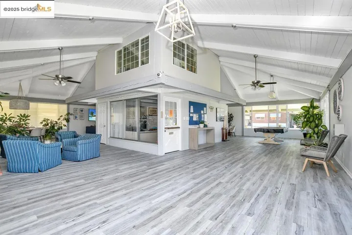 Sunroom with high vaulted ceiling, wood finished floors, and a wood ceiling with exposed beams