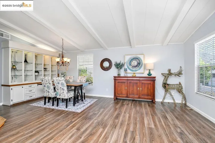 Dining room with wood finished floors and a chandelier