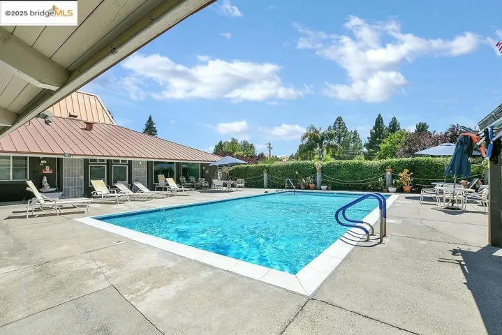 Community pool featuring a patio