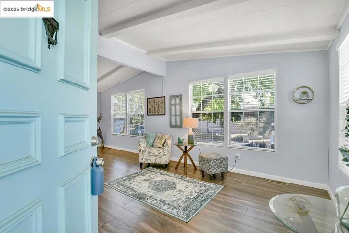 Living area with wood finished floors and baseboards