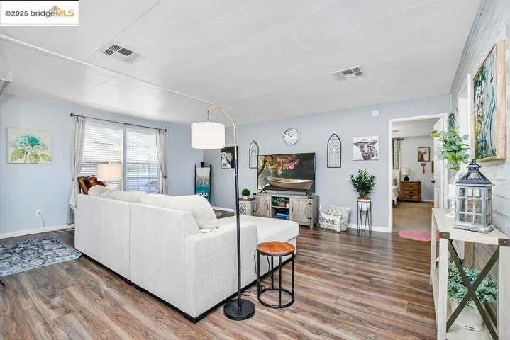 Living area with wood finished floors and baseboards