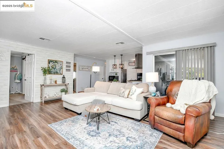 Living area featuring wood finished floors, a barn door, and wooden walls