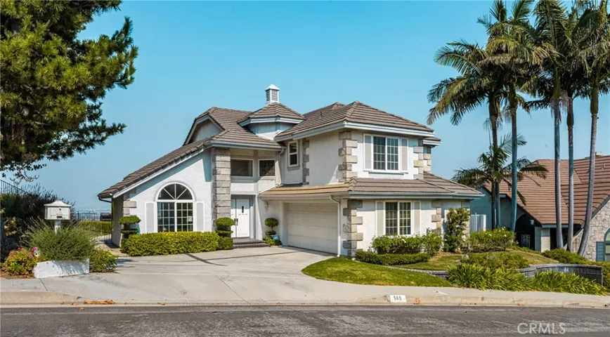 Elegant Two-Story Home with Lush Landscaping and Grand Entryway"

