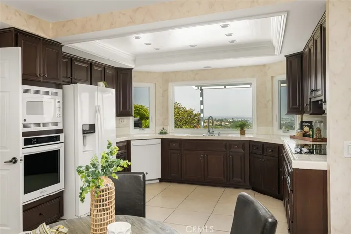 Spacious Eat-In Kitchen with Rich Cabinetry and Scenic Garden Views