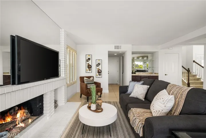 Stylish Family Room with Fireplace, TV Nook, and Direct Access to Wet Bar