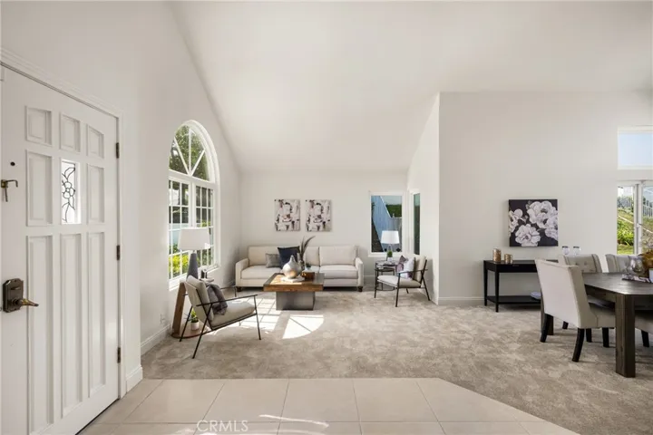 Welcoming Entry with Vaulted Ceilings and Bright, Open Living Spaces