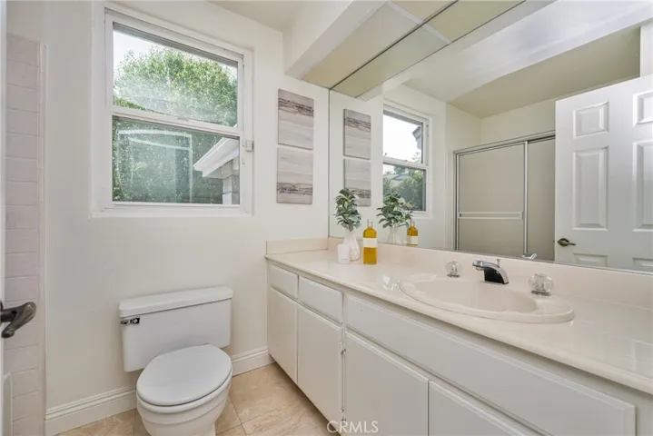 Bright and Clean Guest Bath with Ample Storage and Natural Light