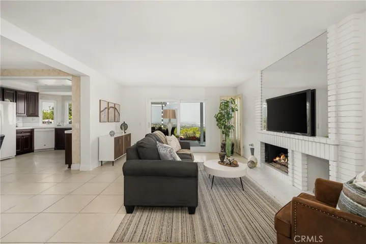 Cozy Family Room with Fireplace, Garden Views, and Seamless Indoor-Outdoor Flow