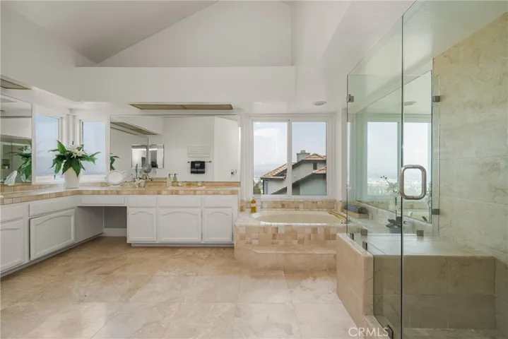 Expansive Primary Bath Retreat with Dual Vanities, Natural Light, and Stunning Views