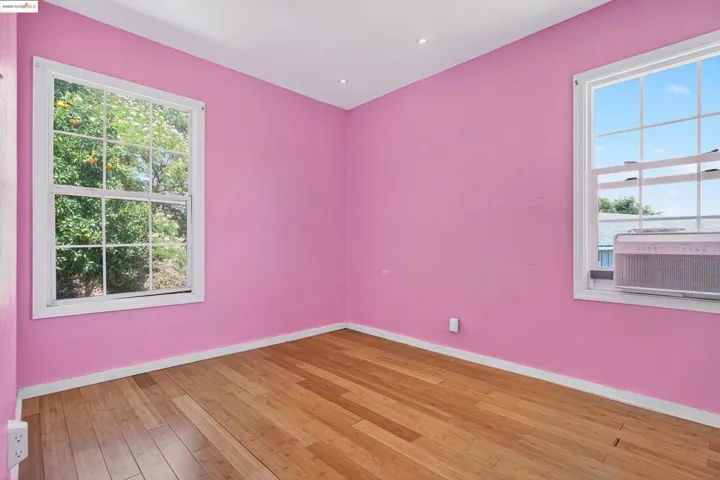 Unfurnished room with plenty of natural light and light wood-style flooring