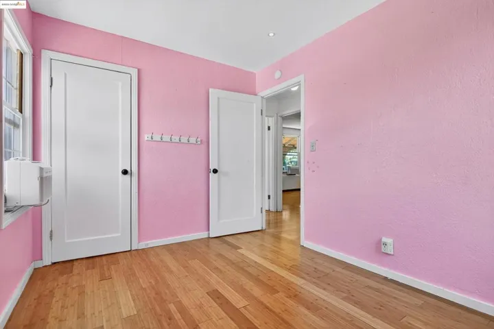 Unfurnished bedroom with light wood-style floors and baseboards