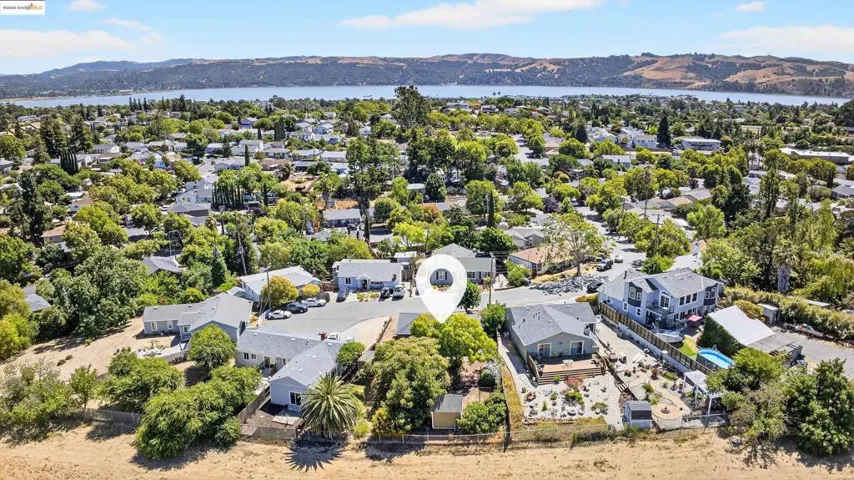 Aerial perspective of suburban area with a water and mountain view