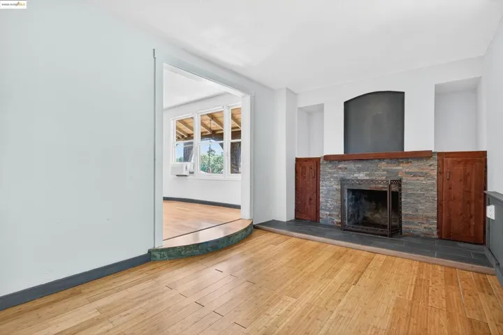 Unfurnished living room featuring wood finished floors and a fireplace