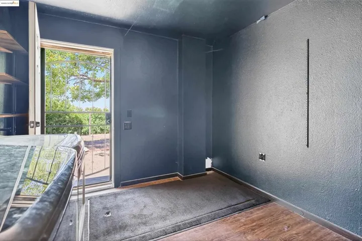 Entryway with a textured wall and wood finished floors