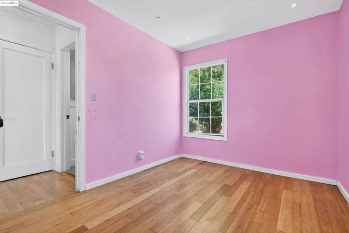Empty room with light wood finished floors and baseboards