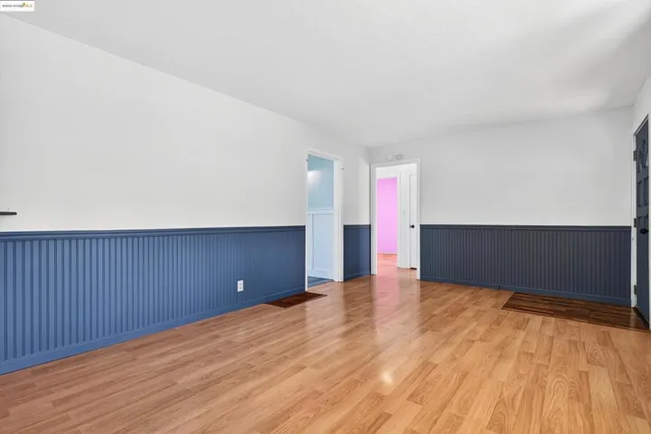 Spare room with a wainscoted wall and wood finished floors