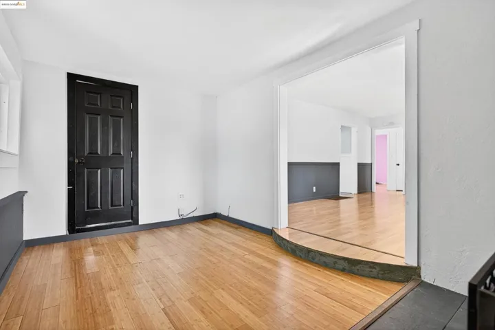 Foyer entrance with wood finished floors and baseboards