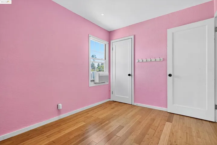 Unfurnished bedroom with a textured wall and light wood finished floors
