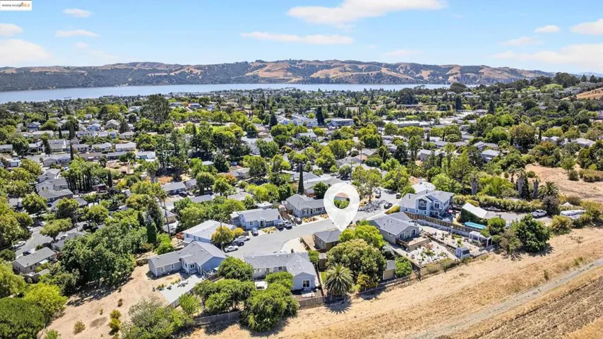Aerial view of residential area featuring a water and mountain view