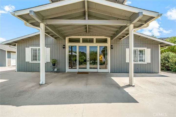 Expansive covered front porch/patio area w dual sliding door entrance to the main living area.
