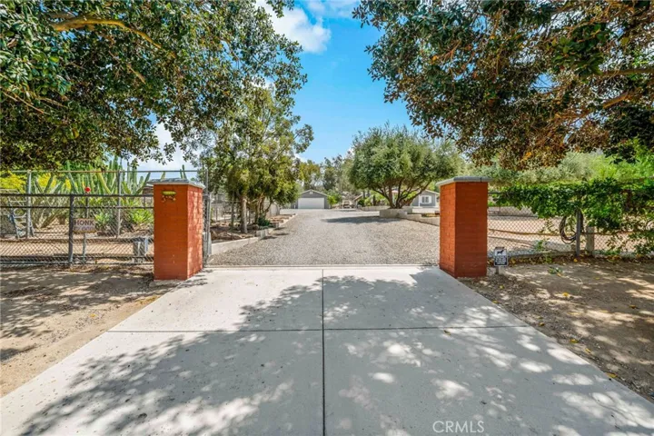Entrance to fenced area around the home w electronic gate.