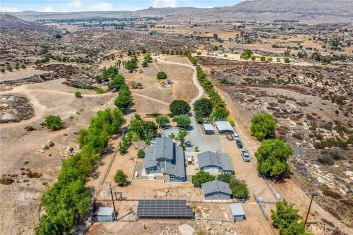 View from the south side of property w ground mounted solar panels (paid for) inside the third fenced area used for goats, donkeys, etc.