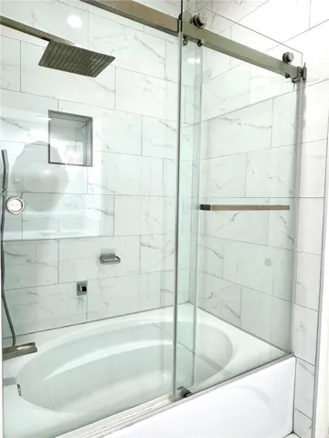 Primary oval bathtub / shower combo - remodeled