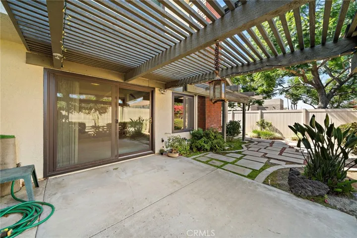 Lovely Tranquil Wrap-Around Backyard Oasis with a Covered Patio, Pergola, and Beautiful Landscaping