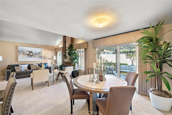 A Full-Size Dining Room is Open to Both the Living Room and the Kitchen with a Sliding Glass Door that Opens to the Patio.