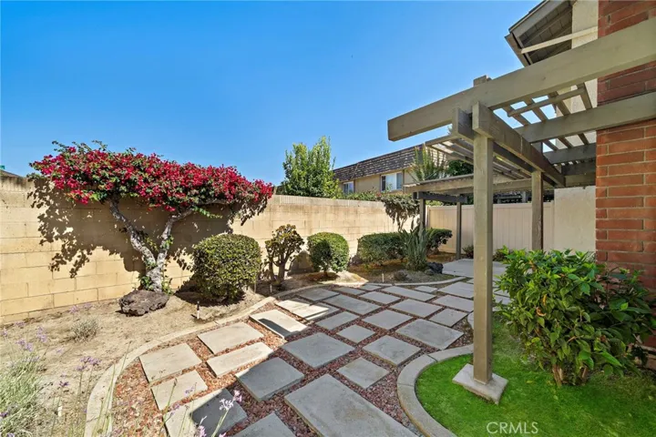 A Lovely Tranquil Wrap-Around Backyard Oasis with a Covered Patio, Pergola, and Beautiful Landscaping