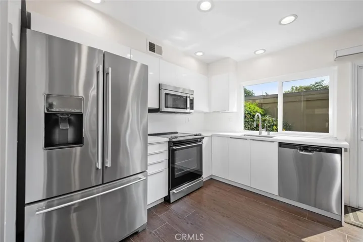 Remodeled kitchen featuring High Gloss European Style Cabinetry.