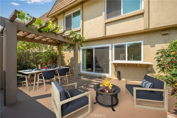 Virtually staged backyard patio area. Grape vines above lattice cover.