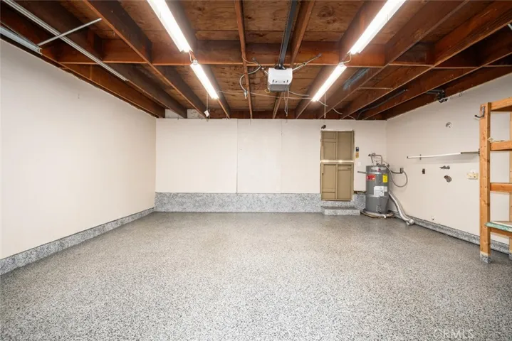 Nicely finished Garage offers automatic roll up garage door opener.