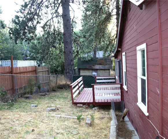 Fenced yard for kids or pets. Side deck off of bedroom 2