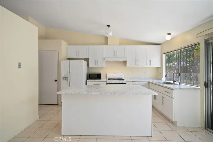 A kitchen remodel completed in 2021 with new shaker cabinetry, high grade laminate countertops, a movable center island, new appliances, and a walk-in​​‌​​​​‌​​‌‌​​‌​​​‌‌​​​‌​​‌‌​​‌‌​​‌‌​​​​ pantry.