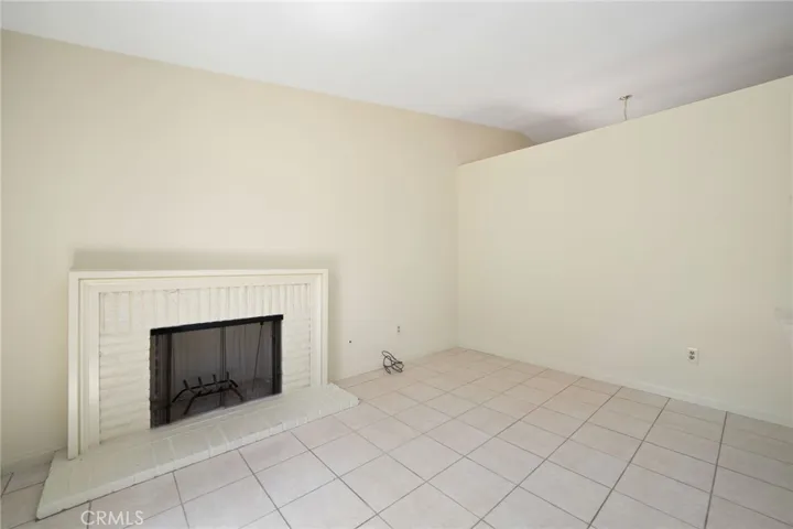 A separate family room with a cozy fireplace provides additional space to gather and relax.