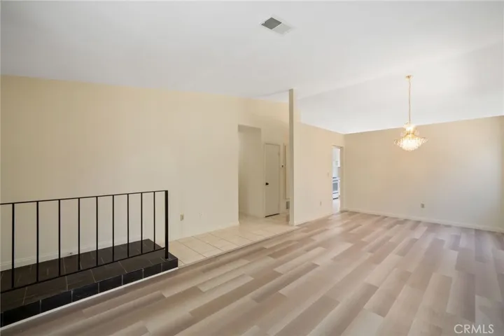 ** Without virtual staging ** The open floor plan connects the kitchen to the spacious living room with soaring ceilings, smooth-finished ceilings, and a formal dining area.