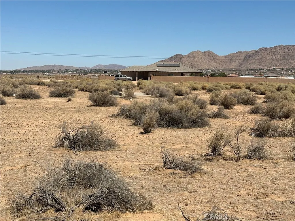 Northern view of lot showing neighboring vacant lot before Ramona Avenue.