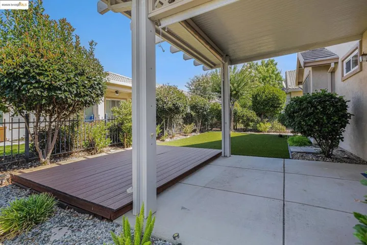 Fenced backyard with a patio area and a wooden deck