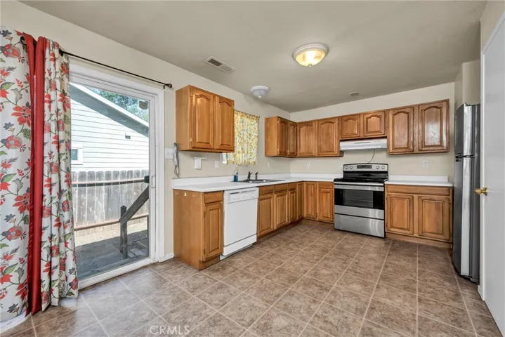 Kitchen opens to eating area, and sliding door to yard.